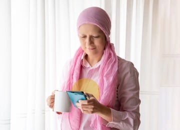 Cancer patient looking at phone