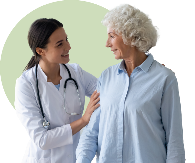 Young female doctor smiling and talking with older female patient