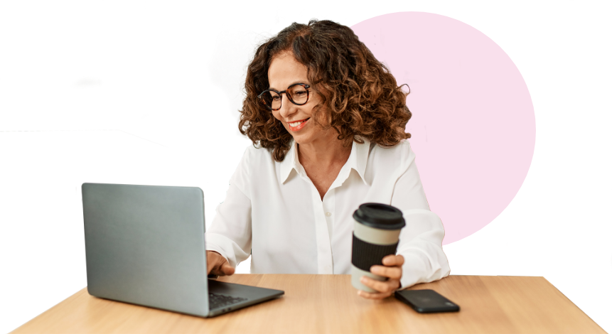 Woman sitting at table drinking coffee while reading blog posts on computer