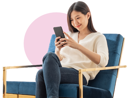 Young asian woman sitting on chair and looking at phone